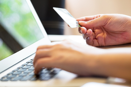 woman holding credit card on laptop for online shopping conceptの写真素材