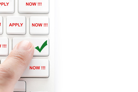 apply job concept : human finger pressing on white keyboard isolated on white backgroundの写真素材