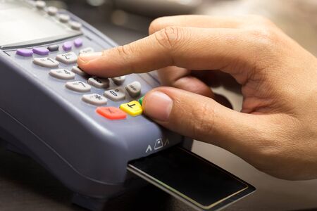 Close Up Of Hand With Credit Card Swipe Through Terminal For Sale In Store