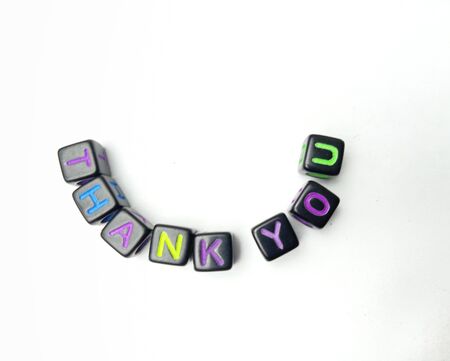 Photo Illustration, Word Thank you from black plastic alphabet cube beadsの写真素材