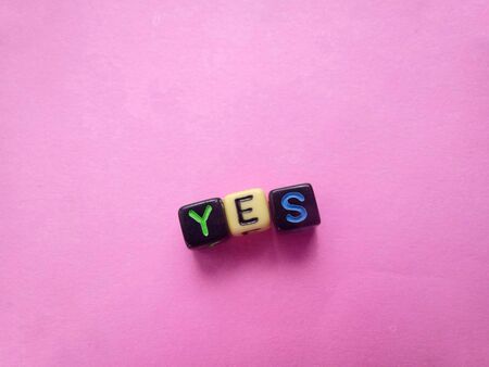 Simple Illustration photo for Yes or accept, made from black plastic alphabet cube beadの写真素材
