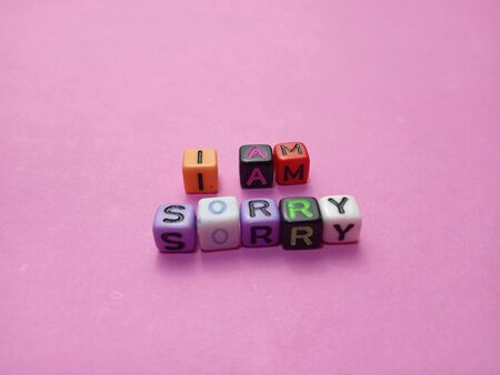Photo Illustration, Word I am Sorry from plastic alphabet cube beads