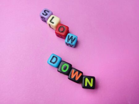 Photo Illustration, Word Slow Down from plastic alphabet cube beadsの写真素材