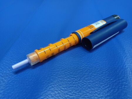 Close Up Photo, Insulin Pen and needles at blue imitation leather bedの写真素材