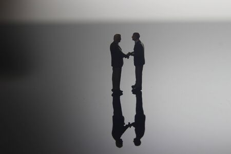 Dramatic Lighting, Simple Illustration Photo for Silhouette Two Man Handshaking for Business...