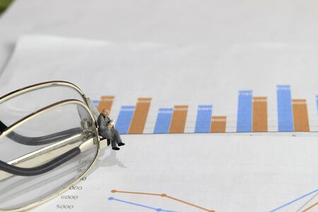 Simple Illustration Photo 1 Sitting Mini Figure old man Toy Reading Graphic Business Chart at...