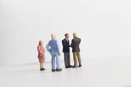 Gray Backgrond, Simple Illustration Photo for Mini Figure Two Man Toy Handshaking for Business Agreement Beyond their partnerの写真素材