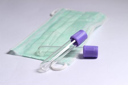 Close Up Photo, Simple Conceptual, Empty Glass Blood Covid-19 Test tube, without label, above N95 Surgical Maskの写真素材