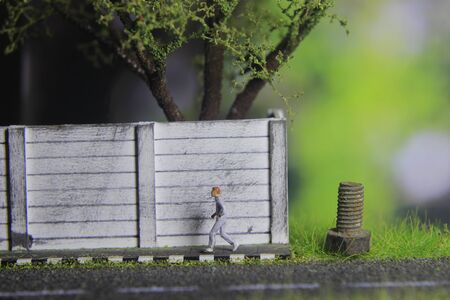 Illustration Photo, Cheap and Easy Sport in the morning, Alone Mini Figure Sport Man Toy at Asphalt Roadの写真素材