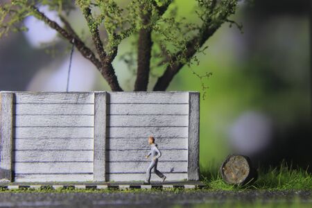 Illustration Photo, Cheap and Easy Sport in the morning, Alone Mini Figure Sport Man Toy at Asphalt Roadの写真素材