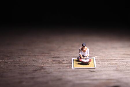 Conceptual Photo, Sitting Muslim, Islam People Reading Al Quran, at Wooden Floorの写真素材