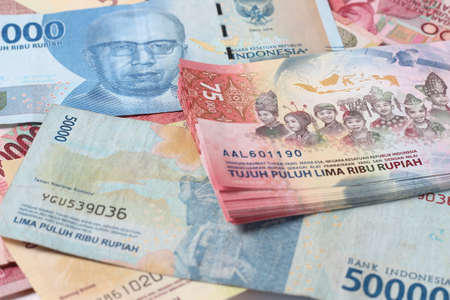 Abstract Random Layout Photo Rupiah Paper Money, 10000, 50000, 100000 and 75000 at White Background