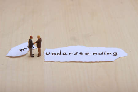 Photo, Ilustration for Change Misunderstanding into understanding, Handshaking 2 businessman mini figure scale 1/87 or HOの写真素材