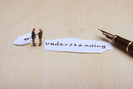Photo, Ilustration for Change Misunderstanding into understanding, Handshaking 2 businessman mini figure scale 1/87 or HOの写真素材
