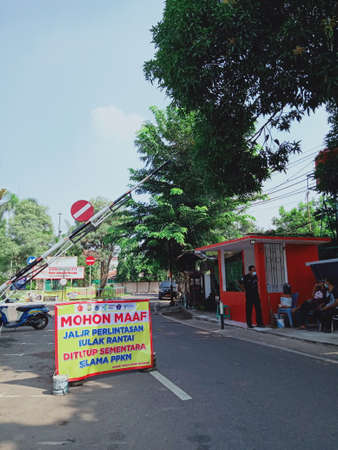 Editorial Photo, 04 July 2021, Indonesia, Gate with Banner that inform that area PPKM or closed due the covid-19 Pandemicのeditorial素材