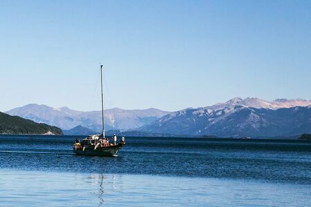 boat in lake with mountainsの写真素材