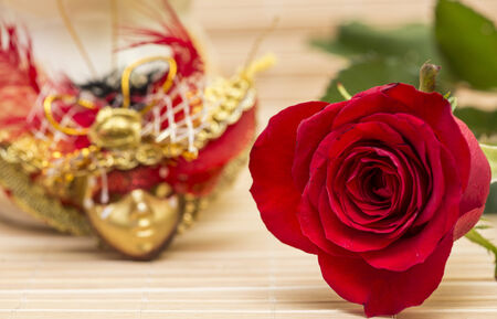 Behind a rose there can be a maskの写真素材