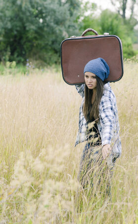A young girl with her suitcaseの写真素材
