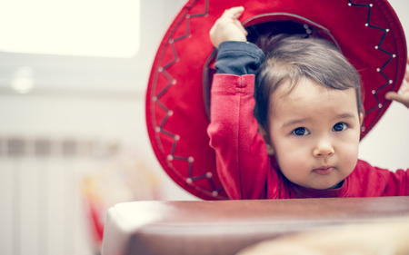 Sweet little cowgirl with a red hatの写真素材