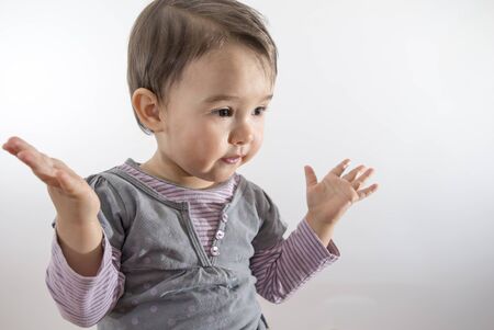 Little girl expressing amazement isolated on white backgroundの写真素材