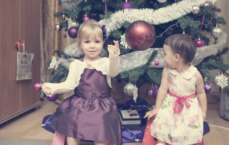little girls near the Christmas treeの写真素材