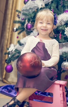 Little and happy girl having fun decoratingの写真素材