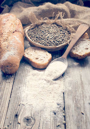 Bread, rye and a spoon with white wheat