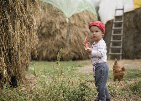 Sweet toddler eating a sweet watermelonの写真素材