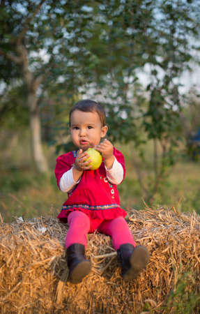 Little girl eating a pearの写真素材
