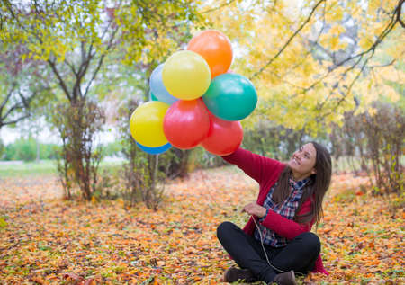 Young and beautiful woman enjoying her balloonsの写真素材