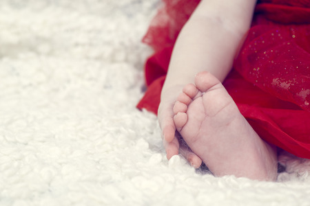 Baby holding his footの写真素材