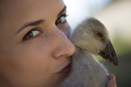 Young girl with spring duckling
