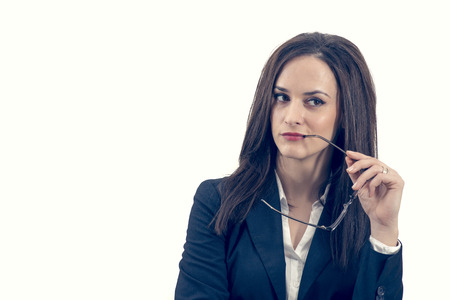 portrait of young business woman holding her eye-glasses, isolated on white backgroundの写真素材