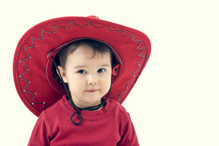 Girl cowboy in a red hat on a white background.の写真素材