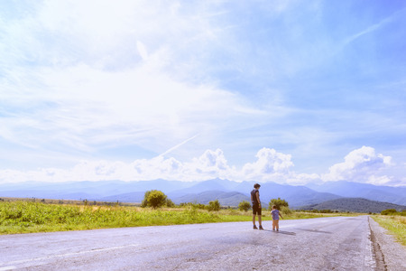 mother with little daughter looking at mountains on vacationの写真素材