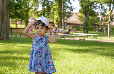 Cute little girl in the park in summer dayの写真素材
