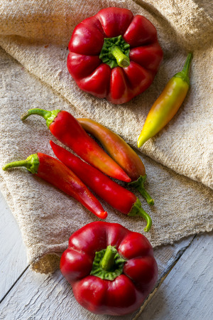 red paprika and pepper on a wooden tableの写真素材