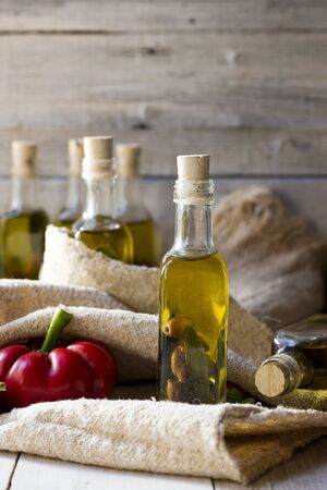 olives and olive oil in mini bottle on wood tableの写真素材