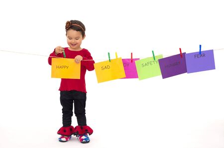 Little girl hanging her feelings on a ropeの写真素材