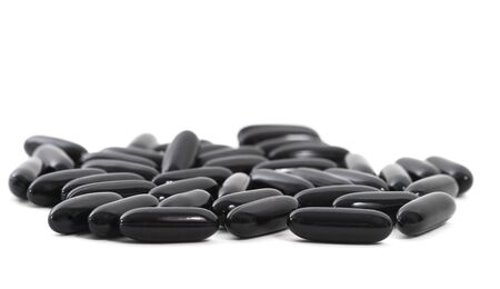 Pharmaceutical Black Pills or Drugs over white backgroundの写真素材