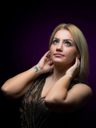 Portrait of beautiful female model on black background