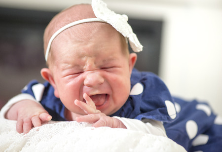 new born baby girl cryingの写真素材