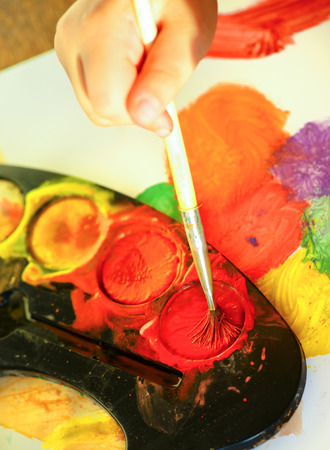 Detail of child's hand painting with watercolorの写真素材
