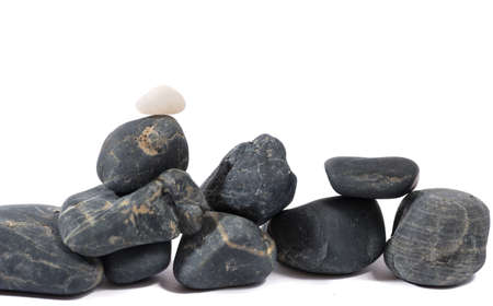 Heap of black stones isolated on whiteの写真素材