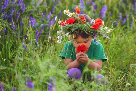 Happy cute child girl on poppies field. Happy children. Healthy lifestyleの写真素材