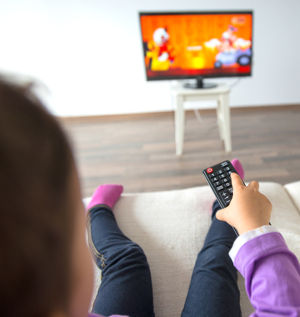 Little kid watching TV in the living roomの写真素材