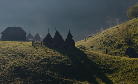 Rural landscape with house in summer sunrise light somewhere in Transylvania Romaniaの写真素材
