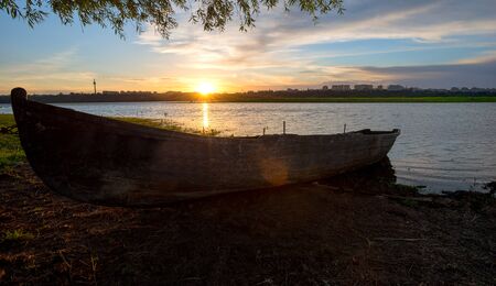 Old fishing boat at sunsetの写真素材