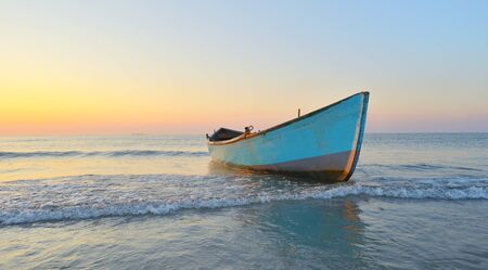 Fishing boat and sunrise on Black Seaの写真素材
