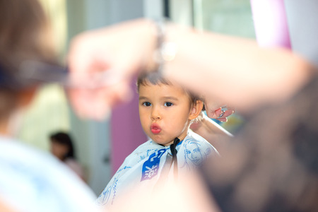 Toddler child getting his first haircutの写真素材